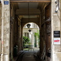 This open wooden door provides a peak into the apartment block